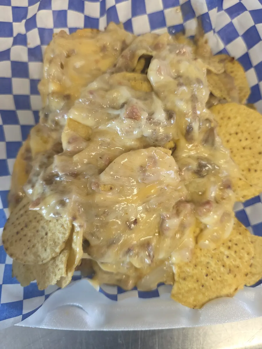 The basket fully covered in melted cheese, sirloin and hotlink