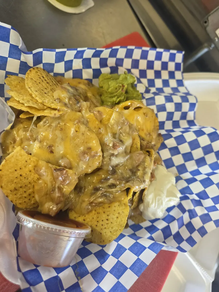 The finished 12th Man Nachos with guacamole, sour cream and a cup of hot salsa
